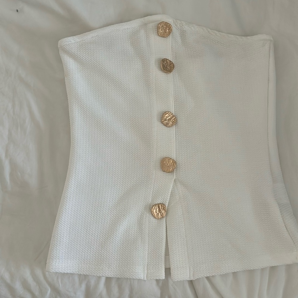 White sleeveless top with gold buttons